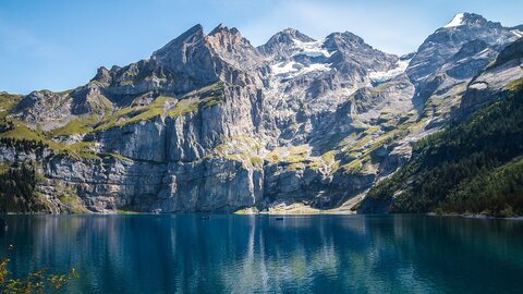A large dark blue lake surrounded by mountains