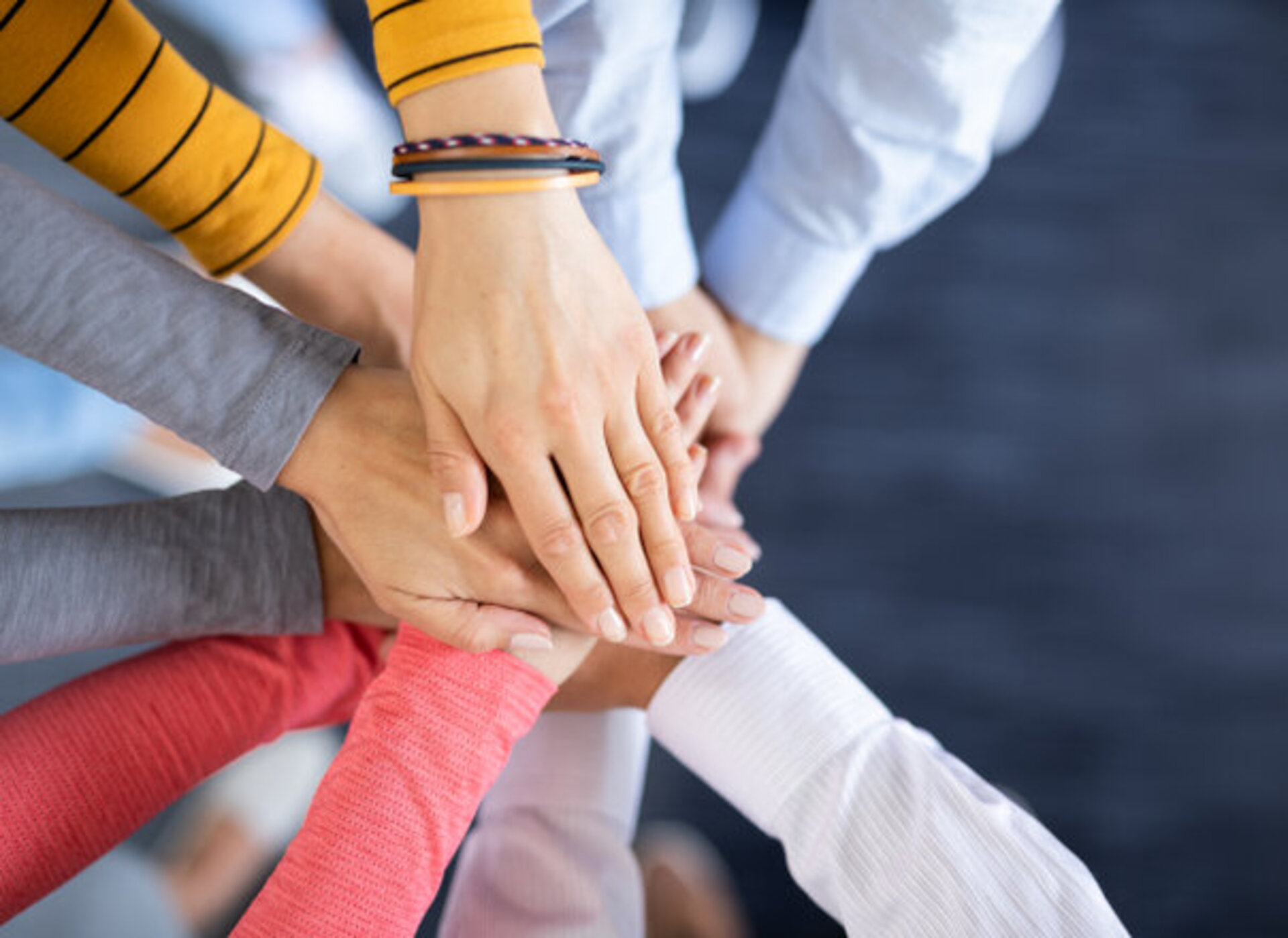 Several hands touching each other