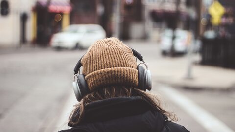 Teenager with brown beanie and big headphones