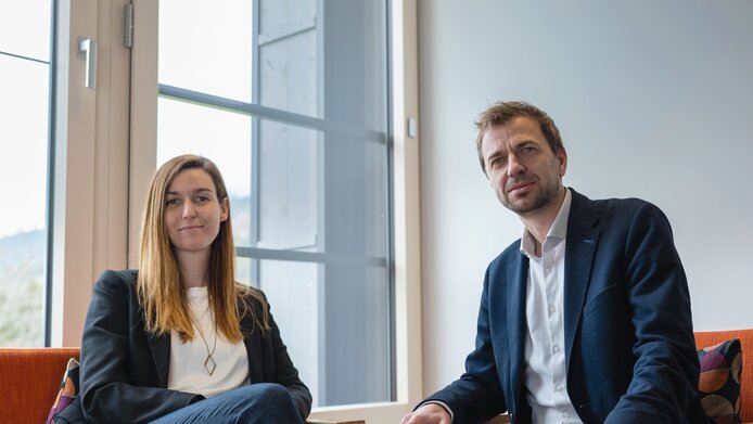 Magdalena Hauser and Wolfgang Lechner on red armchairs
