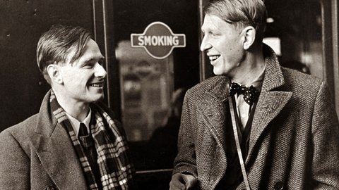 Black-and-white photograph of W. H. Auden (right) and his friend Christopher Isherwood at Victoria Station, London in 1938